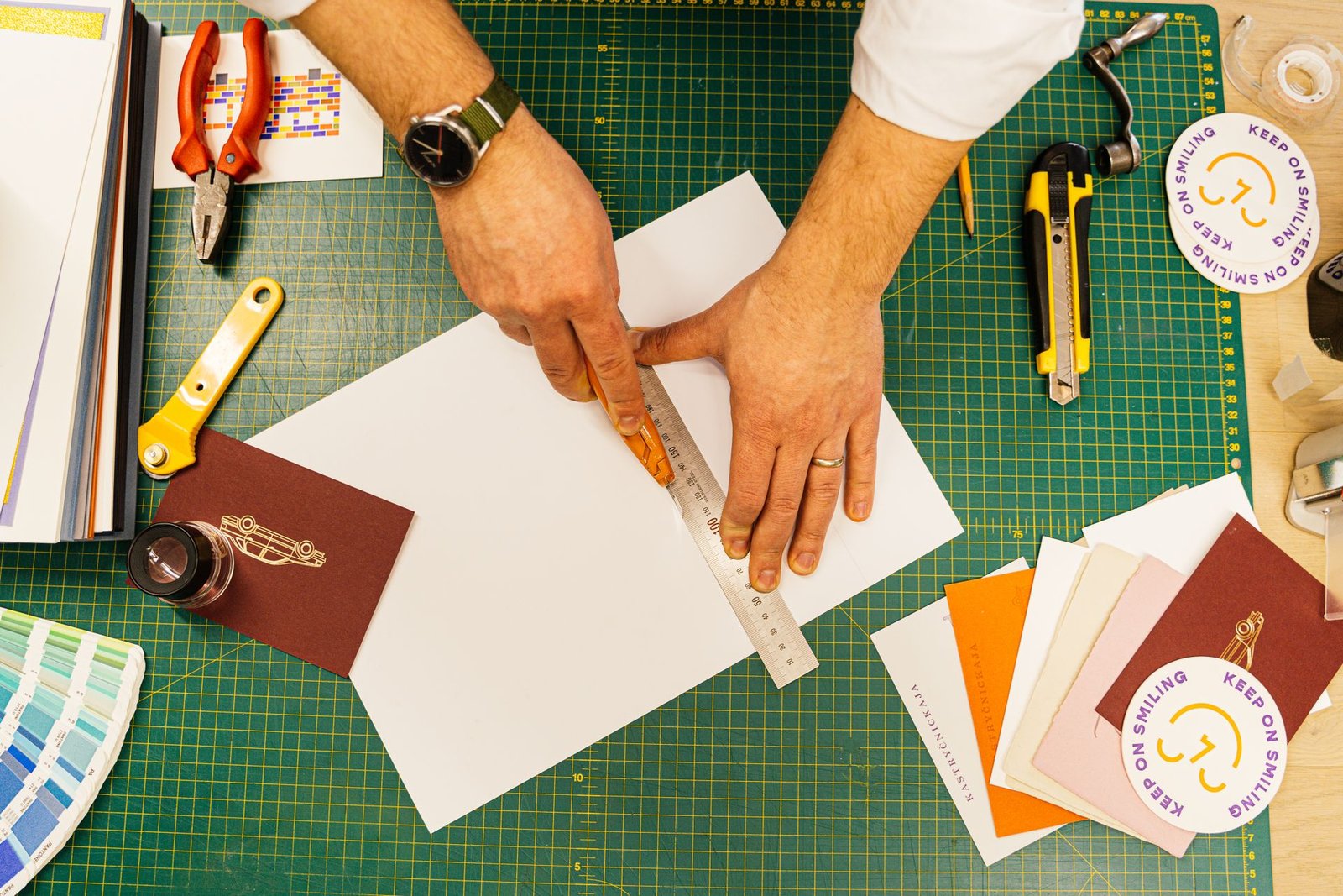 A designer working with colourful paper in the studio