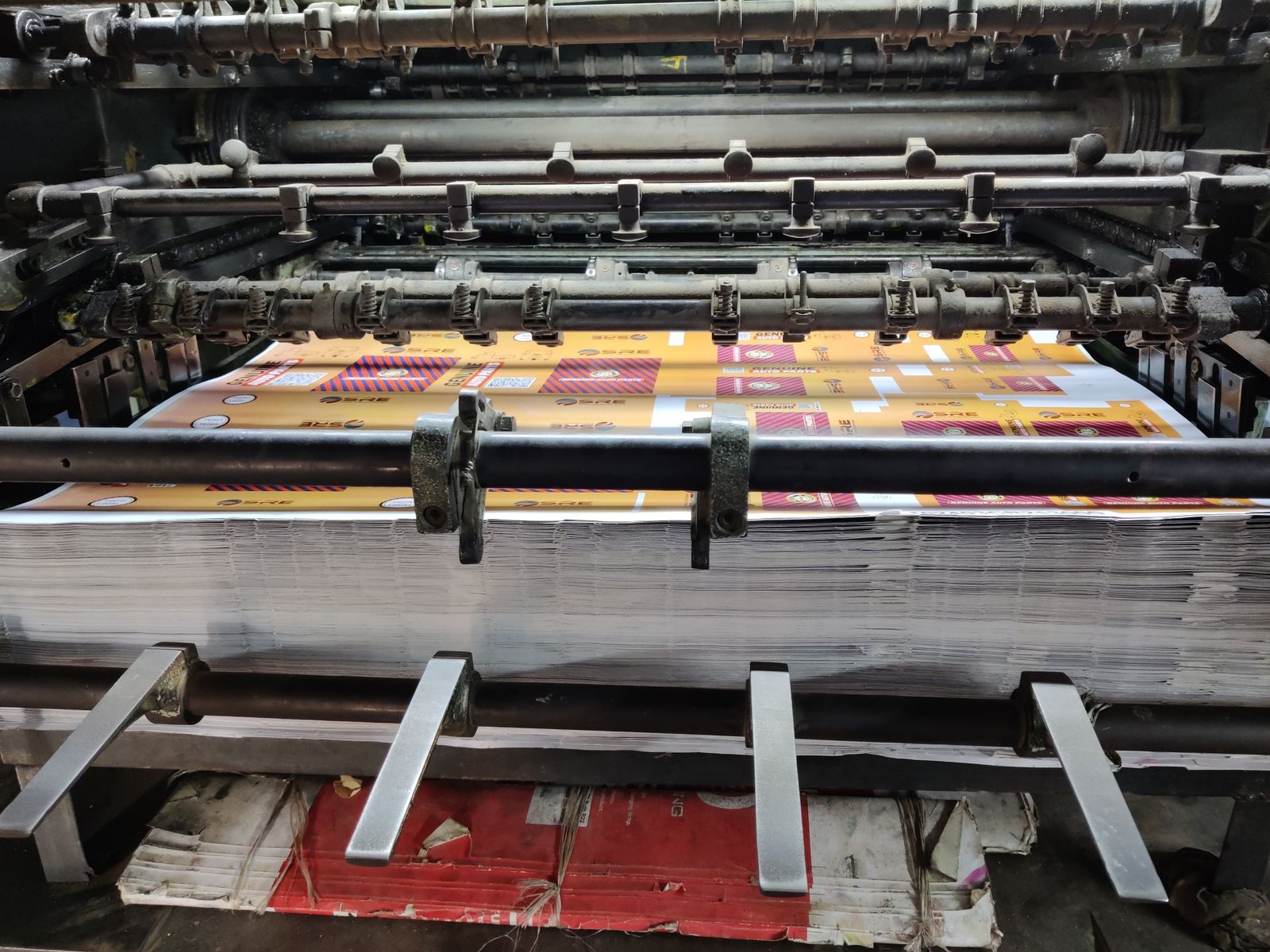 Catalogue & Brochure Design An offset press running colourful printed sheets
