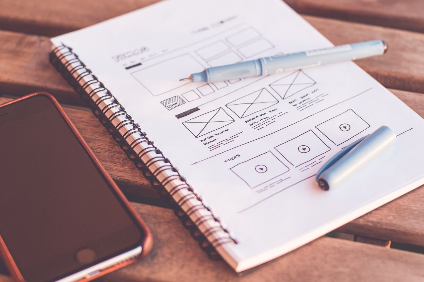 Home Wireframe sketches and colourful notes on a designer desk