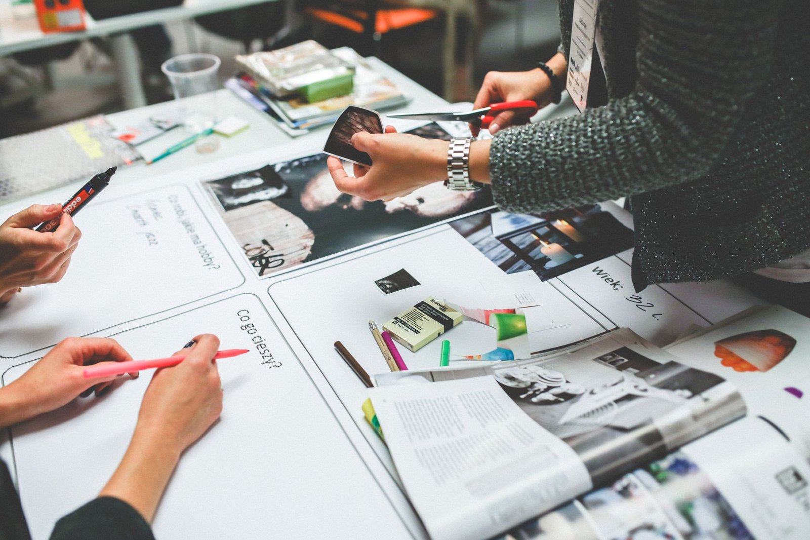 Designers reviewing printed layouts together on a studio table
