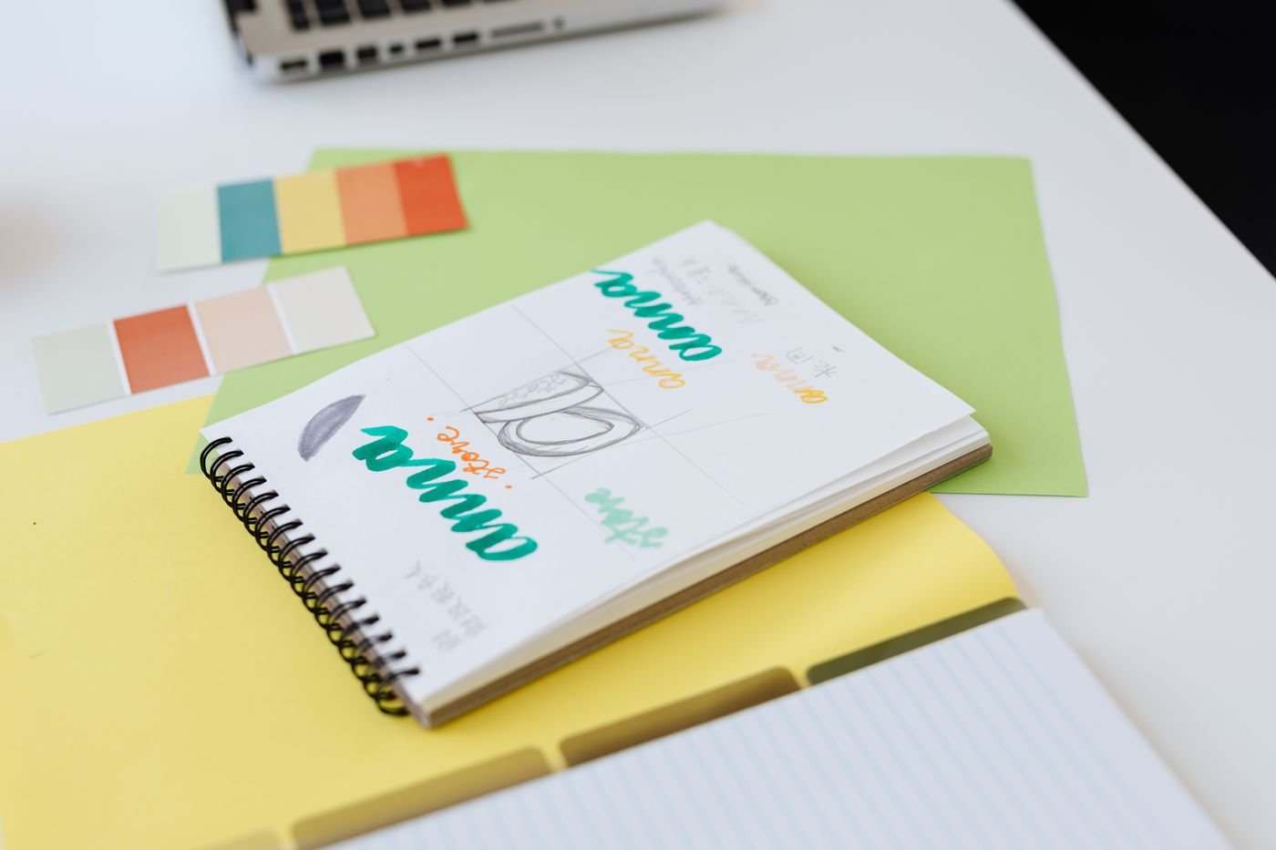 Logo sketches and branding notes in a designer notebook