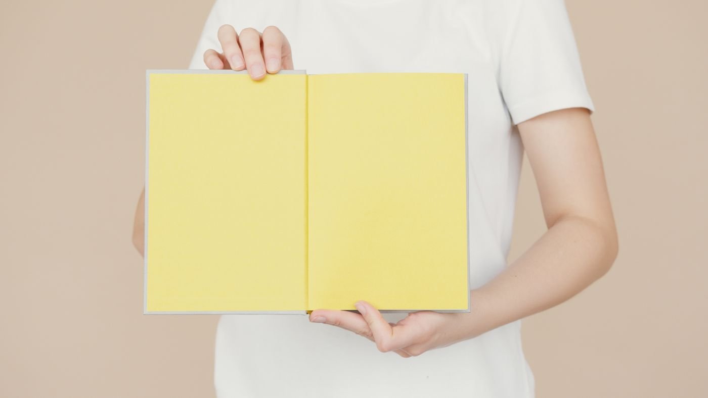 A brand guidelines book open on colourful pages